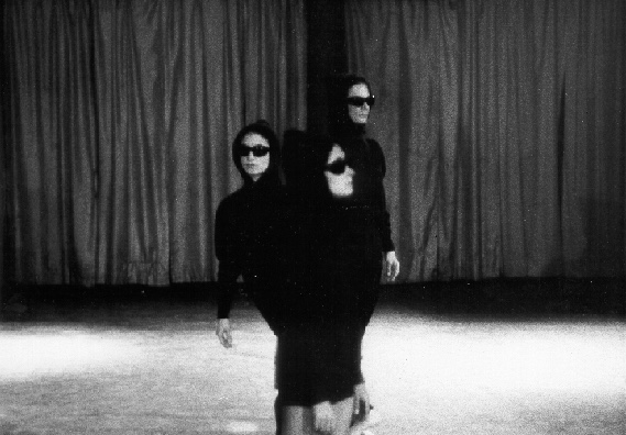 Jenkins, Rudner, Tharp in Twelve Foot Change wearing sunglasses and parkas and standing in a line